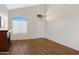 The bright and spacious living area has a fireplace and natural light from multiple windows and high ceilings at 19616 N Toya St, Maricopa, AZ 85138