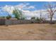 Large backyard with a tall block wall, some shade, and a play house at 2425 W Shady Glen Ave, Phoenix, AZ 85023