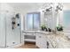 Updated bathroom featuring white cabinets, granite countertop, and walk-in shower at 2425 W Shady Glen Ave, Phoenix, AZ 85023
