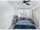 Bright bedroom with a large window, closet, chair, and bookcase at 2425 W Shady Glen Ave, Phoenix, AZ 85023