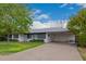 Inviting exterior featuring a well-maintained lawn, a brick facade, and a convenient carport at 2425 W Shady Glen Ave, Phoenix, AZ 85023