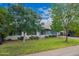 Beautifully landscaped front yard with mature trees providing ample shade at 2425 W Shady Glen Ave, Phoenix, AZ 85023