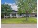 Charming single-story home with lush green lawn, mature trees, and covered carport at 2425 W Shady Glen Ave, Phoenix, AZ 85023