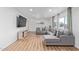 Stylish living room featuring a plush gray sectional, contemporary decor, and large windows at 2425 W Shady Glen Ave, Phoenix, AZ 85023