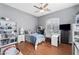 Well-lit bedroom with a work desk, a bookcase, a comfortable bed, and a large window at 2452 W Enfield Way, Chandler, AZ 85286