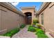 Inviting front entryway with a brick path, lush greenery, and a charming bench leading to the front door at 2452 W Enfield Way, Chandler, AZ 85286