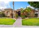 Charming single-story home with desert landscaping, manicured lawn, and a tiled roof in a sunny setting at 2452 W Enfield Way, Chandler, AZ 85286