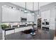 Modern kitchen featuring white cabinetry, a dark countertop island, and stainless steel appliances at 2452 W Enfield Way, Chandler, AZ 85286
