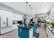 Bright and open kitchen with a center island, white cabinets, stainless steel appliances, and an eat-in area at 2452 W Enfield Way, Chandler, AZ 85286