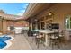 Outdoor kitchen and bar area featuring a built-in grill, ample counter space, and comfortable seating at 2452 W Enfield Way, Chandler, AZ 85286