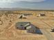 Expansive aerial view of desert homesite with custom home and mountain backdrop at 25721 W Running Deer Trl, Wittmann, AZ 85361