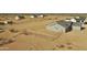 Aerial view showing desert home's fenced lot featuring a large backyard at 25721 W Running Deer Trl, Wittmann, AZ 85361