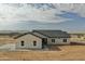 Single-story home with modern architectural style, desert landscape, and concrete driveway at 25875 W Running Deer Trl, Wittmann, AZ 85361