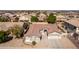 A beautiful aerial shot of the house situated in a lively neighborhood featuring desert landscaping and tiled roofs at 2612 W Summerside Rd, Phoenix, AZ 85041