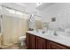 Bright bathroom with a double sink vanity, framed mirror and a shower and tub combination at 2612 W Summerside Rd, Phoenix, AZ 85041