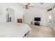 A well-lit main bedroom featuring a ceiling fan and neutral carpeting at 2612 W Summerside Rd, Phoenix, AZ 85041