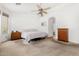Well-lit bedroom features neutral carpeting and a ceiling fan at 2612 W Summerside Rd, Phoenix, AZ 85041
