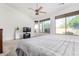 A bright main bedroom featuring many windows, neutral carpeting and a ceiling fan at 2612 W Summerside Rd, Phoenix, AZ 85041