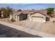 Charming single-story home featuring a tile roof, well-manicured desert landscaping, and a spacious three-car garage at 2612 W Summerside Rd, Phoenix, AZ 85041