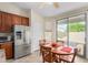 Bright eat-in kitchen featuring a stainless steel refrigerator and access to the backyard at 2612 W Summerside Rd, Phoenix, AZ 85041
