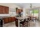 A kitchen with stainless steel appliances, breakfast bar, light fixtures, and a dining table near a window at 2612 W Summerside Rd, Phoenix, AZ 85041
