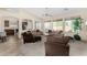 Open-concept living room with arched doorways, carpet flooring, and generous natural light at 2612 W Summerside Rd, Phoenix, AZ 85041