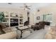 Comfortable living room with ample seating, a ceiling fan, and a TV entertainment center at 2612 W Summerside Rd, Phoenix, AZ 85041