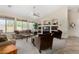 Bright living room featuring large windows, a ceiling fan, and comfortable seating at 2612 W Summerside Rd, Phoenix, AZ 85041
