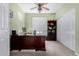 Comfortable home office featuring a ceiling fan, window, and storage, perfect for remote work or study at 2612 W Summerside Rd, Phoenix, AZ 85041