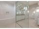 Modern bathroom featuring tile flooring, a glass shower, white cabinets, and neutral countertops at 26696 W Siesta Ln, Buckeye, AZ 85396