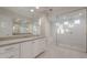 Bathroom with tile floor, white cabinets, neutral countertops, and a glass walk-in shower at 26696 W Siesta Ln, Buckeye, AZ 85396