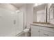 Modern bathroom with tiled shower and sleek vanity with gray countertop at 26696 W Siesta Ln, Buckeye, AZ 85396