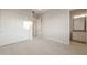 A light-filled bedroom with carpet and an en-suite bathroom at 26696 W Siesta Ln, Buckeye, AZ 85396