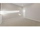 An empty room with neutral carpet and a walk-in closet at 26696 W Siesta Ln, Buckeye, AZ 85396