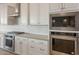 Close-up view of a gourmet kitchen with stainless steel appliances and white cabinets at 26696 W Siesta Ln, Buckeye, AZ 85396