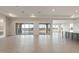 Bright and airy living room with tile floors and glass doors to the outdoors at 26696 W Siesta Ln, Buckeye, AZ 85396
