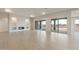 Spacious living room featuring a fireplace and floor-to-ceiling sliding glass doors at 26696 W Siesta Ln, Buckeye, AZ 85396