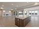 Open floor plan showcases a kitchen island connecting to a spacious living area with a fireplace at 26696 W Siesta Ln, Buckeye, AZ 85396