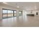 Open-concept living space featuring tile floors, a kitchen, and large sliding doors at 26696 W Siesta Ln, Buckeye, AZ 85396