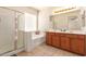 Bathroom with a tub, shower, and vanity with double sinks and good lighting at 3107 S 74Th Ln, Phoenix, AZ 85043