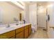 Bathroom featuring a double sink vanity, a toilet, and a shower with glass door at 3107 S 74Th Ln, Phoenix, AZ 85043