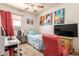Bedroom featuring carpet flooring, ceiling fan, bed, TV, and a red chair at 3107 S 74Th Ln, Phoenix, AZ 85043