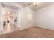 Spacious bedroom area with neutral carpet, adjoining bathroom, and a view of living spaces at 3107 S 74Th Ln, Phoenix, AZ 85043