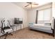 Bedroom featuring carpet flooring, ceiling fan, bed, gaming chair, and TV at 3107 S 74Th Ln, Phoenix, AZ 85043