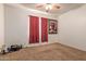 Carpeted bedroom featuring a ceiling fan, a window, and a floral painting at 3107 S 74Th Ln, Phoenix, AZ 85043