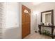 Welcoming foyer showcasing a decorative door, stylish console table, and neutral decor at 3107 S 74Th Ln, Phoenix, AZ 85043