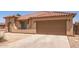 Attached two-car garage with extended driveway offering convenience and ample parking space at 3107 S 74Th Ln, Phoenix, AZ 85043