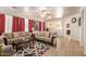 Comfortable living room featuring tile floors, neutral sofas, and a decorative area rug at 3107 S 74Th Ln, Phoenix, AZ 85043