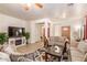 Bright living room featuring neutral tones, tile flooring, and comfortable seating arrangement at 3107 S 74Th Ln, Phoenix, AZ 85043
