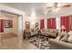 Open-concept living room featuring neutral decor, tile flooring, and comfortable seating arrangements at 3107 S 74Th Ln, Phoenix, AZ 85043